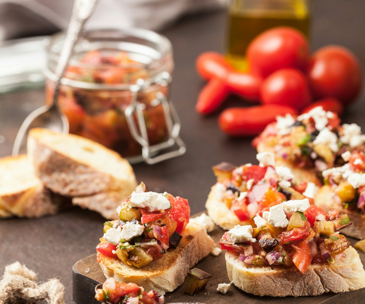 Jars of sauces and bruschetta on a table
